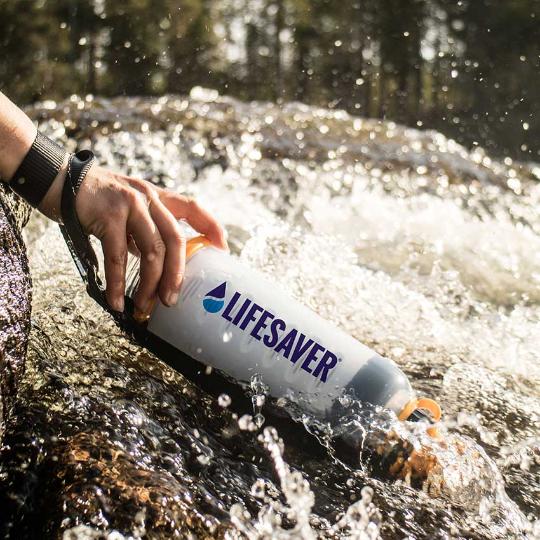 Carregar imagem no visualizador da galeria, LifeSaver water purifier bottle being used to filter moving river water