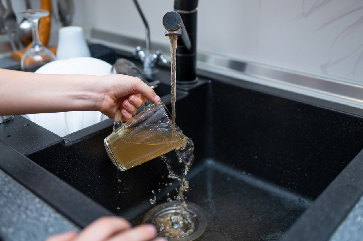 Dirty brown water coming through a kitchen tap