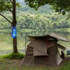 Camping tent by a lake and a Lifeline Gravity Bag hanging from a tree
